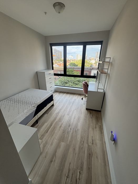 Clean bedroom with fresh floors and city view